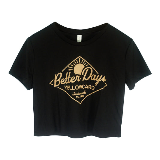 The Better Days - Black Crop T-Shirt features a tan sun graphic with "Better Days," "YELLOWCARD," and "Jacksonville EST. 1997" in a diamond design on the front.