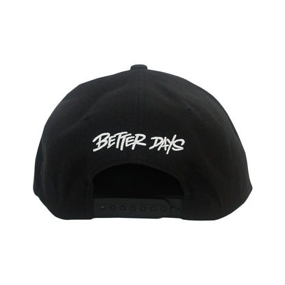 The Better Days Logo - Black Snapback features "BETTER DAYS" in white, stylized embroidery above the adjustable strap—a perfect, quality choice for fans of embroidered hats.