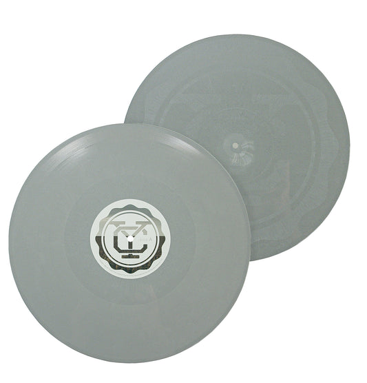 Two translucent gray "Self Titled - Gray - 2xVinyl LP" records overlap on a white background. One has a geometric, circular center label; the other shows subtle grooves and a faint design. "Leave A Light On" is included.