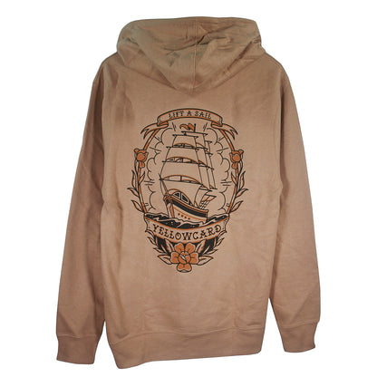 The Tattoo Ship - Sandstone Pullover is a tan hoodie with a large traditional sailing ship graphic, floral accents, and banners reading “LIFT A SAIL” and “YELLOWCARD.”.